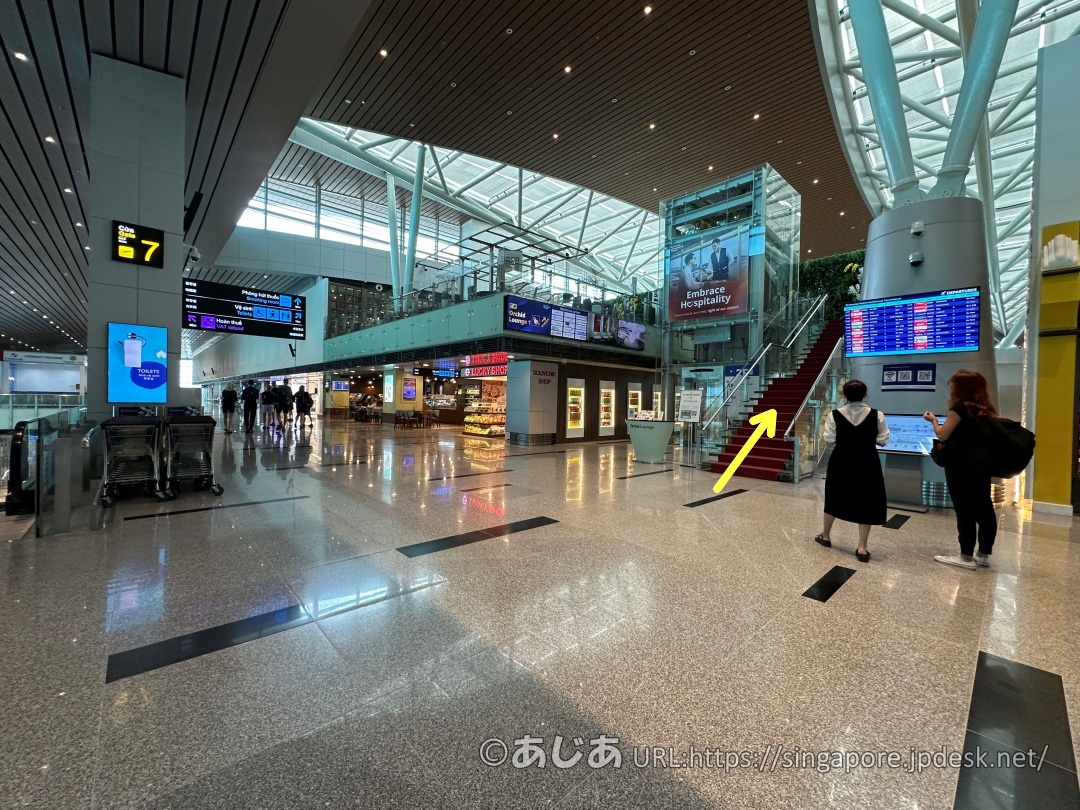 CIP Orchid Loungeへ向かう階段とエスカレーターを示す矢印