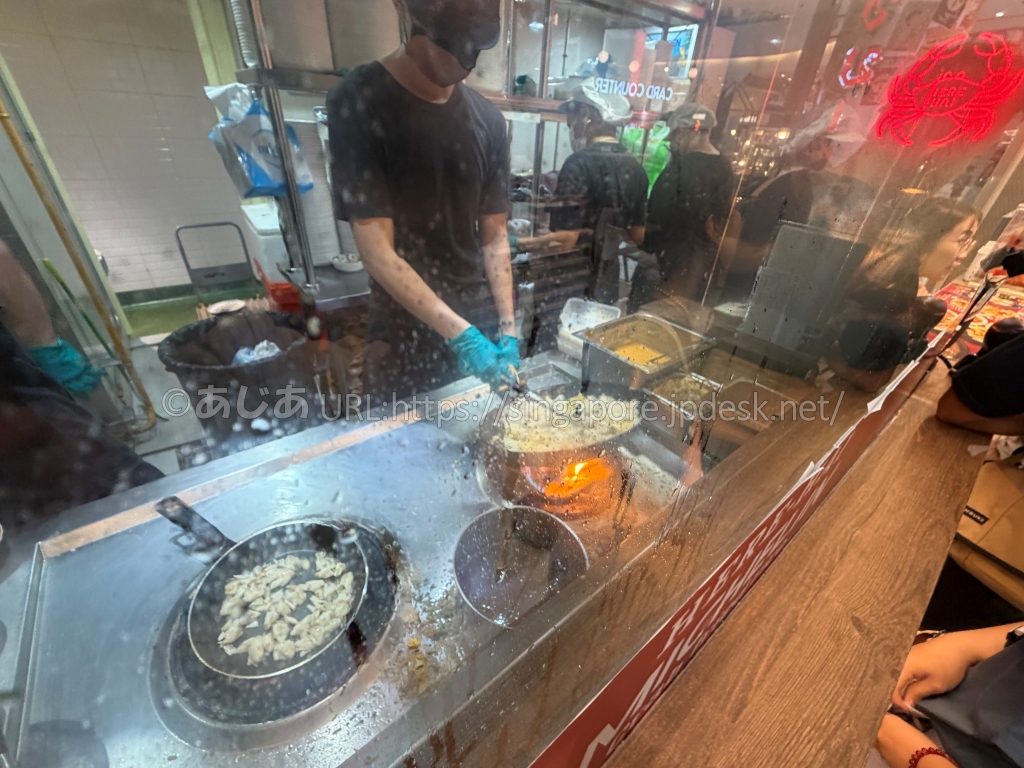 HERE HAIの厨房で蟹肉チャーハンを強火調理する様子