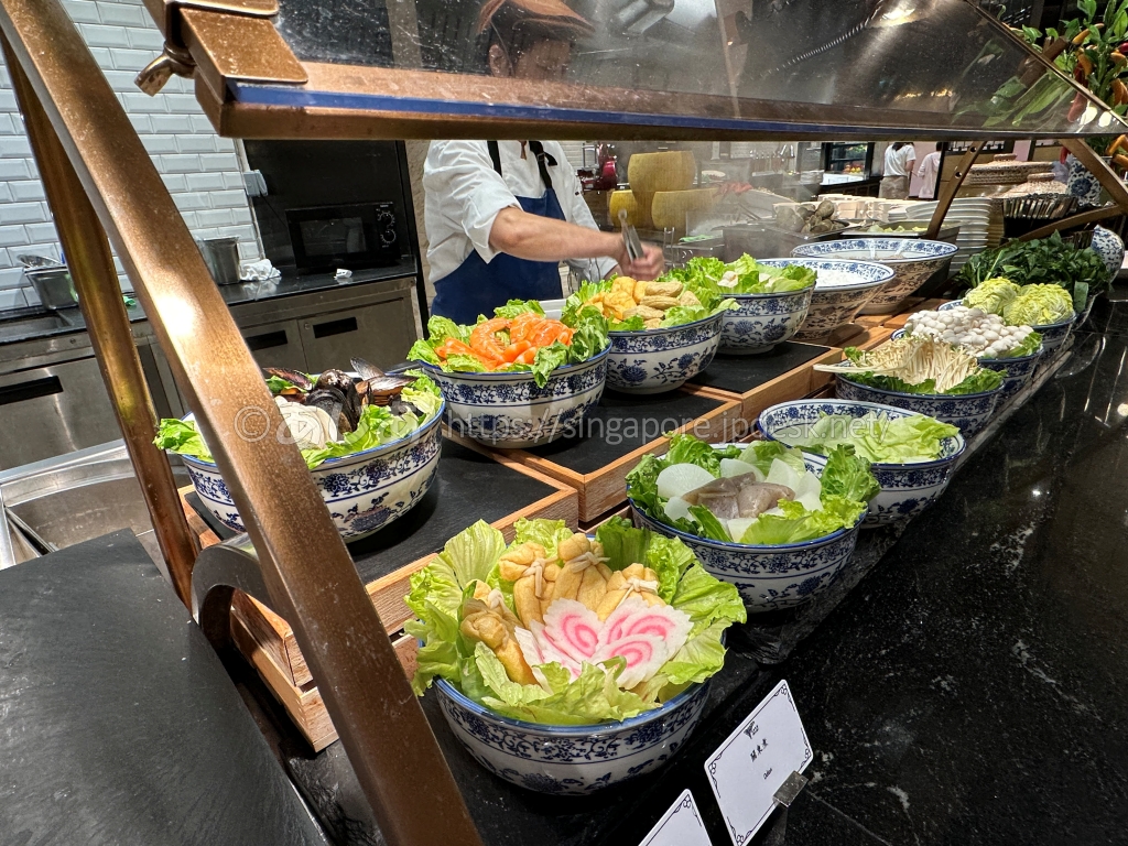スポットライトの海鮮麺用の貝、魚、野菜、きのこが入った器